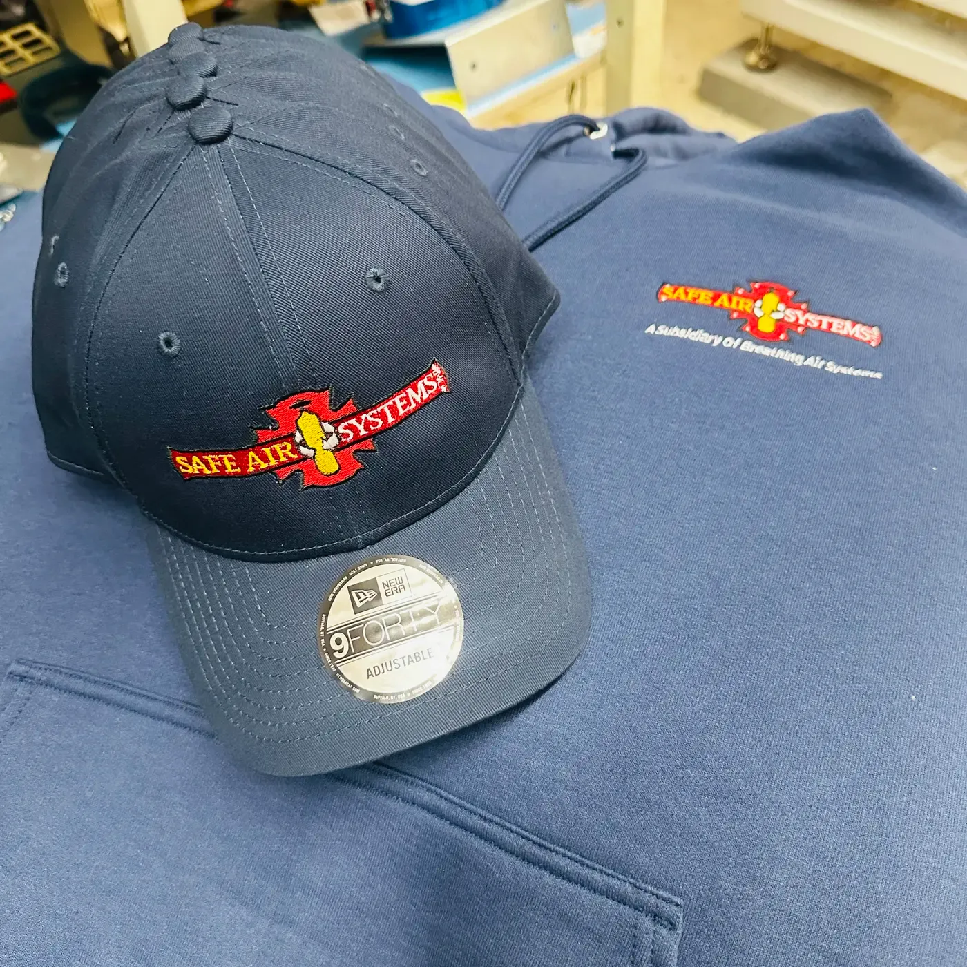 Custom embroidered cap and hoodie by Carolina Sports Accessories